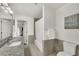 Well-lit bathroom featuring a granite vanity, modern fixtures, and a bathtub with shower; inspirational wall art at 1420 Cortez Ne Ln, Atlanta, GA 30319