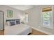 Inviting bedroom with a patterned bedspread, ambient lighting, and two windows at 1420 Cortez Ne Ln, Atlanta, GA 30319