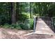 Scenic view of the community walking bridge surrounded by mature trees and natural landscape at 1420 Cortez Ne Ln, Atlanta, GA 30319