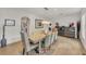 Bright dining room features a modern light fixture, seating for eight, and wood floors at 1420 Cortez Ne Ln, Atlanta, GA 30319