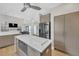 Open-concept kitchen featuring stainless steel appliances and sleek, modern cabinetry at 1420 Cortez Ne Ln, Atlanta, GA 30319