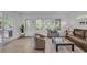 Bright living room featuring hardwood floors, comfortable seating, and abundant natural light from large windows at 1420 Cortez Ne Ln, Atlanta, GA 30319