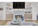 A cozy living room features a stone fireplace, a mounted TV, and built-in shelving at 1420 Cortez Ne Ln, Atlanta, GA 30319