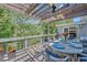 Outdoor deck with a covered dining area, grill, and beautiful view of the surrounding trees and pond at 1420 Cortez Ne Ln, Atlanta, GA 30319