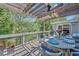 Relaxing outdoor deck featuring a pergola, dining space, and scenic views of lush trees at 1420 Cortez Ne Ln, Atlanta, GA 30319