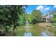 Scenic pond view featuring lush landscaping and a tranquil fountain at 1420 Cortez Ne Ln, Atlanta, GA 30319