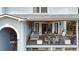 View of a cozy, covered back deck with comfortable seating and a great view of the trees and backyard at 1420 Cortez Ne Ln, Atlanta, GA 30319