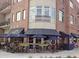 A restaurant with covered outdoor seating on the corner of a brick building at 1420 Cortez Ne Ln, Atlanta, GA 30319