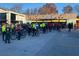 Group of cyclists in front of SAVI food wine and spirits in a shopping area at 1420 Cortez Ne Ln, Atlanta, GA 30319