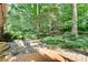 Charming backyard featuring a stone patio surrounded by lush landscaping and decorative string lights at 2167 Tanglewood Rd, Decatur, GA 30033