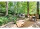 Beautiful backyard with a spacious deck including a dining table set and a custom chicken coop at 2167 Tanglewood Rd, Decatur, GA 30033