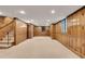 Spacious basement with wood-paneled walls, neutral carpet, and recessed lighting, perfect for flexible living space at 2167 Tanglewood Rd, Decatur, GA 30033