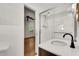 Bathroom with white quartz counter tops, modern faucet, glass-enclosed shower, and open doorway at 2167 Tanglewood Rd, Decatur, GA 30033