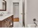 Bathroom featuring white subway tile, marble counters, dark wooden vanity, and adjacent door to tub at 2167 Tanglewood Rd, Decatur, GA 30033