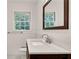 Bathroom with marble counter, dark wooden vanity and modern faucet, with window to the outside at 2167 Tanglewood Rd, Decatur, GA 30033