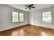 Bright bedroom with hardwood floors, a ceiling fan, and two windows with yard views at 2167 Tanglewood Rd, Decatur, GA 30033