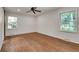 Bedroom with hardwood floors, ceiling fan, and windows with views of the yard at 2167 Tanglewood Rd, Decatur, GA 30033