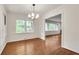Bright dining room with hardwood floors, a modern chandelier, and large windows at 2167 Tanglewood Rd, Decatur, GA 30033
