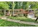 Charming brick home featuring a front-facing garage, stone walkway, and professionally landscaped yard at 2167 Tanglewood Rd, Decatur, GA 30033