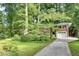 Beautiful brick house with a well-maintained lawn, mature trees, and an attached front facing garage at 2167 Tanglewood Rd, Decatur, GA 30033
