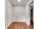 Inviting entryway with hardwood floors, a white door, and fresh paint throughout at 2167 Tanglewood Rd, Decatur, GA 30033