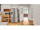 Stylish kitchen showcasing stainless steel refrigerator and adjacent dining area at 2167 Tanglewood Rd, Decatur, GA 30033