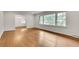 Bright living room featuring pristine hardwood floors, white walls, and large windows offering lots of light at 2167 Tanglewood Rd, Decatur, GA 30033