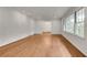 Bright living room with hardwood flooring, white walls, and natural light streaming through the windows at 2167 Tanglewood Rd, Decatur, GA 30033