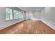 Open living space with hardwood floors, white walls, and large windows providing plenty of natural light at 2167 Tanglewood Rd, Decatur, GA 30033
