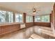 Bright sunroom with brick walls, multiple windows, and a ceiling fan at 2167 Tanglewood Rd, Decatur, GA 30033
