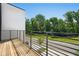Private balcony with wood floors and metal railings offering views of the surrounding greenery at 2202 Carlton Ct # 7, Atlanta, GA 30318