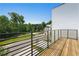 Modern balcony with wooden floors and metal railings overlooking a quiet street and green landscape at 2202 Carlton Ct # 7, Atlanta, GA 30318