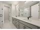 Bathroom features double vanity, quartz counters, glass shower, and white tile floors at 2202 Carlton Ct # 7, Atlanta, GA 30318