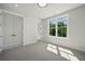 Bright bedroom features large window, carpeted floor, and closet with double doors at 2202 Carlton Ct # 7, Atlanta, GA 30318