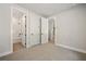 An empty bedroom showcases neutral colors, carpet, and access to both a bathroom and hallway at 2202 Carlton Ct # 7, Atlanta, GA 30318