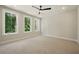 Bright and airy bedroom with a ceiling fan and three large windows at 2202 Carlton Ct # 7, Atlanta, GA 30318