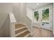 A bright entryway featuring wood stairs, a large window, and a white door at 2202 Carlton Ct # 7, Atlanta, GA 30318