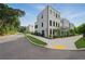 A modern white townhome featuring manicured landscaping and a private balcony at 2202 Carlton Ct # 7, Atlanta, GA 30318