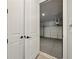 View of a clean garage with a concrete floor and an automatic door opener, accessible through a set of white doors at 2202 Carlton Ct # 7, Atlanta, GA 30318