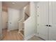 Hallway features wood-look floors, a staircase, and white doors with black hardware at 2202 Carlton Ct # 7, Atlanta, GA 30318