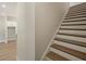 Elegant staircase with wood treads and white risers next to an opening to a room at 2202 Carlton Ct # 7, Atlanta, GA 30318
