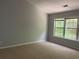 Bright bedroom featuring a large window and neutral carpet, ready for personalization at 3118 Stanstead Ct, Norcross, GA 30071