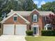 Beautiful brick home with green shutters, a well-kept lawn, and mature trees at 3118 Stanstead Ct, Norcross, GA 30071