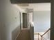 Upstairs hallway with multiple doors leading to other rooms and view of the staircase at 3118 Stanstead Ct, Norcross, GA 30071