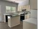 Spacious kitchen features white cabinets, black appliances, and a center island at 3118 Stanstead Ct, Norcross, GA 30071