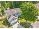 Aerial view of a traditional two-story home with an attached garage and mature landscaping at 1095 Lyndhurst Way, Roswell, GA 30075