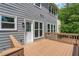 Back deck with grey siding and a door and windows at 1095 Lyndhurst Way, Roswell, GA 30075