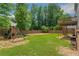 Large backyard with a wooden playset and deck with stairs at 1095 Lyndhurst Way, Roswell, GA 30075