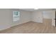 Bright basement with wood-look flooring, window, and an open floorplan at 1095 Lyndhurst Way, Roswell, GA 30075