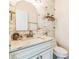 Updated powder room with unique wall tile and marble countertop at 1095 Lyndhurst Way, Roswell, GA 30075